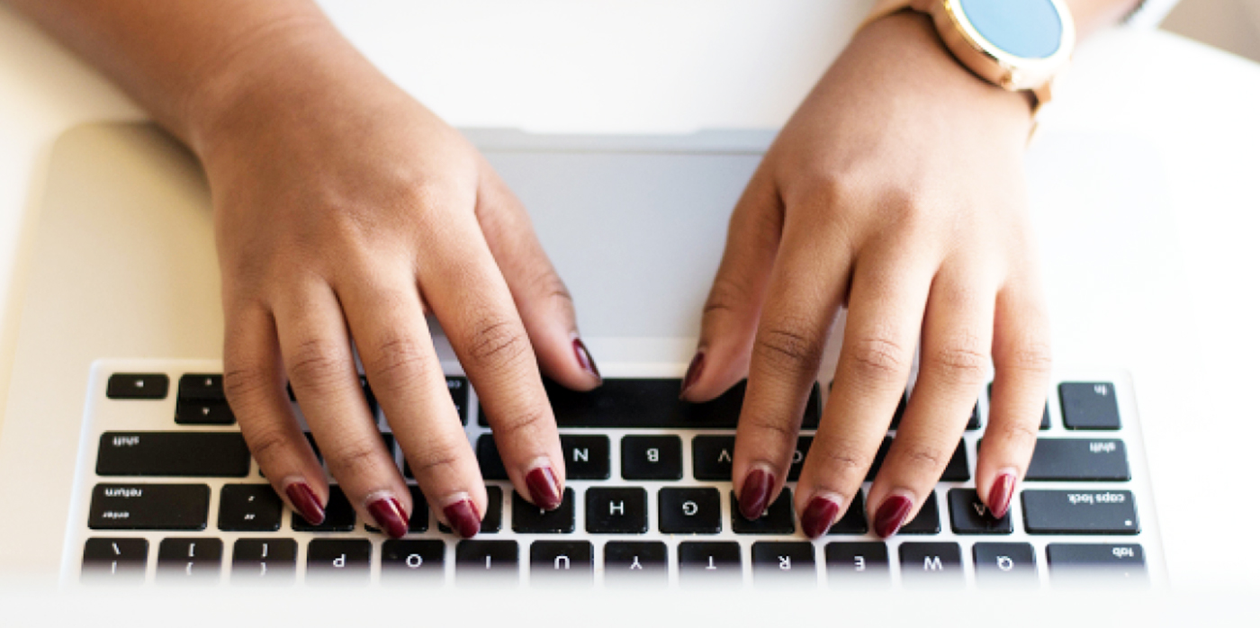 female hands typing on keyboard