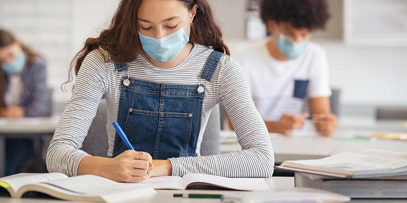 Year 11 student with surgical mask on sitting at desk in classroom