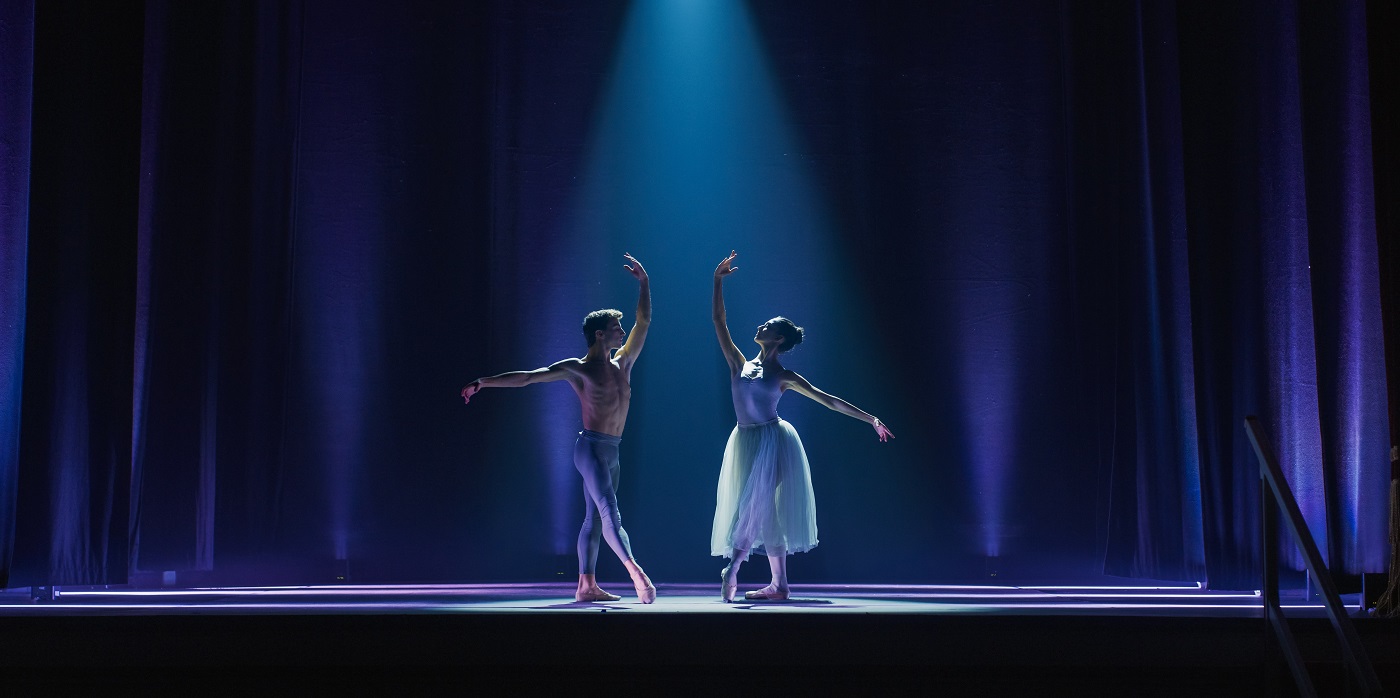 Classical ballet dancers performing in theatre