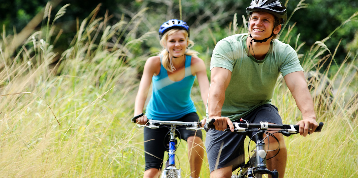 Couple cycling in countryside