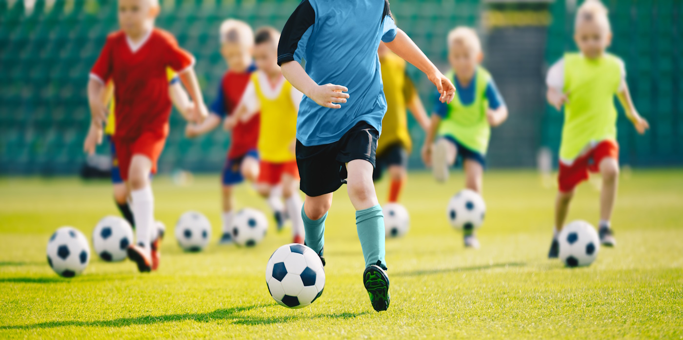 Kids running with football