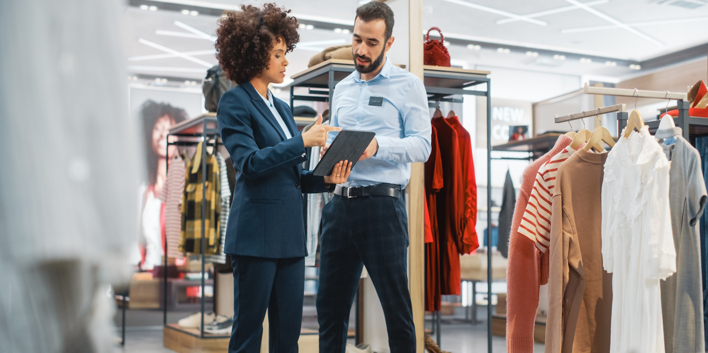 Man and woman in store looking at a tablet